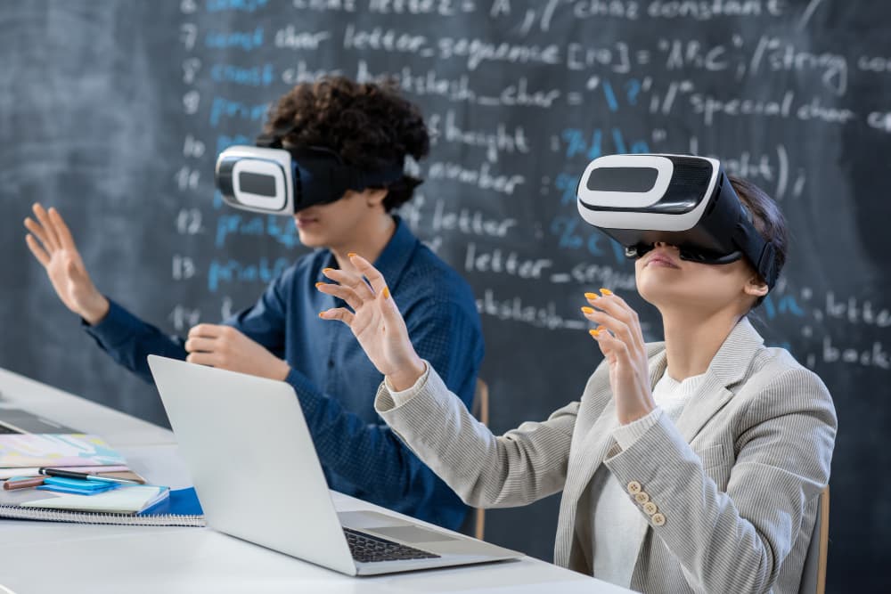 Teacher and student using VR headsets in a classroom with code written on the chalkboard