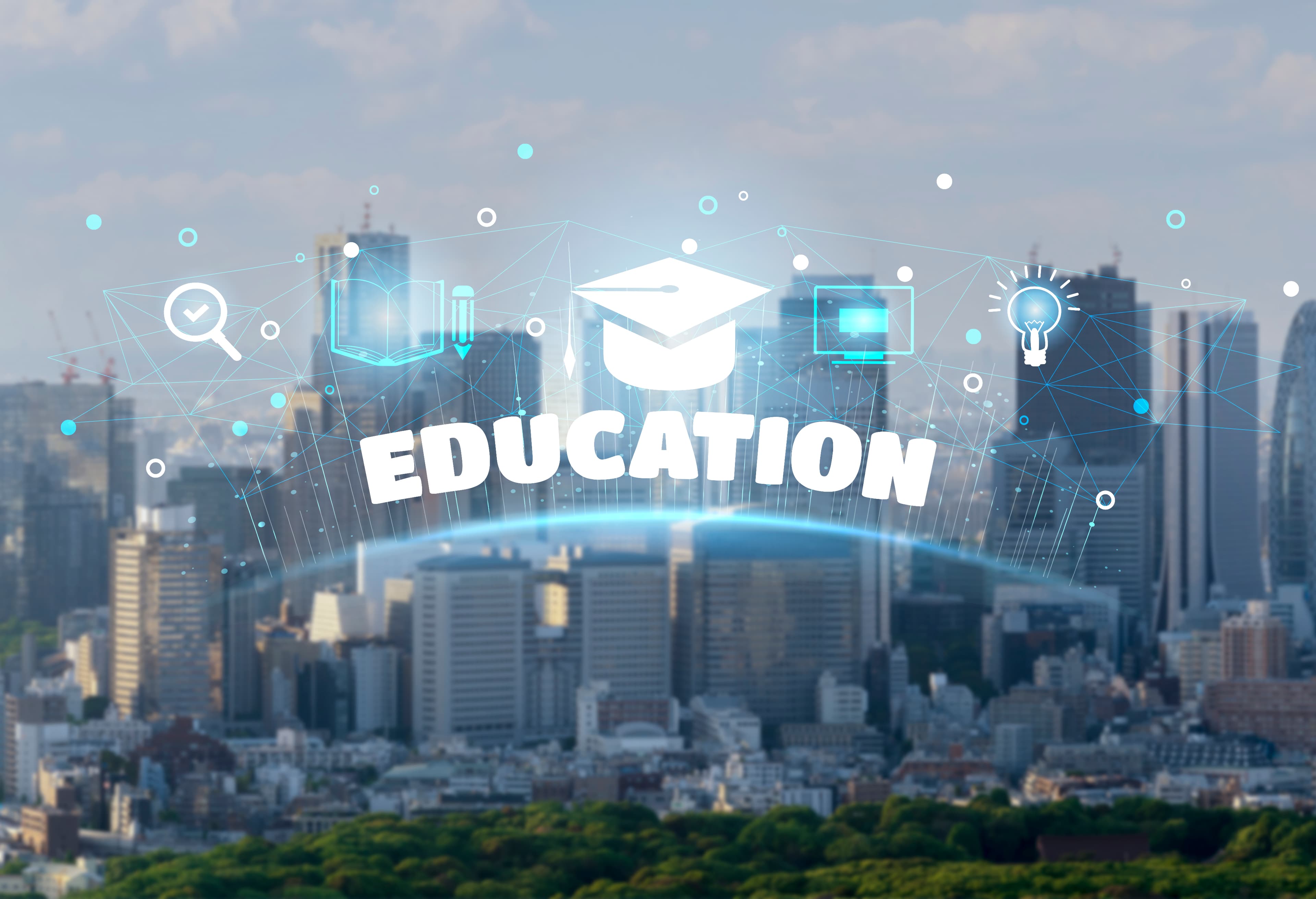 City skyline overlaid with a graduation cap and education icons